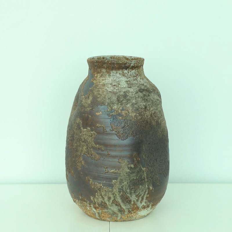 Handmade rounded irregular stoneware ceramic vase with wabi-sabi textures, perfect for retro home decor.
